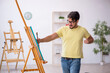 © Elnur - Young man enjoying painting at home