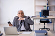 © Elnur - Old male employee working in the office