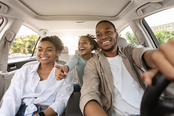 Wall Mural - Joyful Black Family Having Road Trip Sitting In New Car