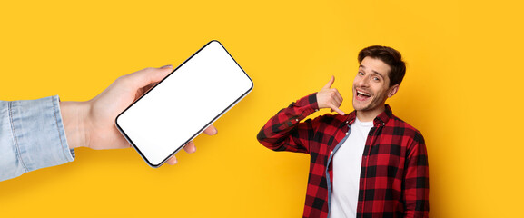 Wall Mural - Man showing blank empty smartphone screen and call me sign