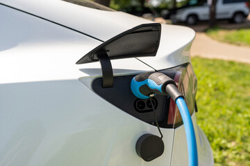 Electric car charging at plug in charge station in a public car park in Suffolk, UK