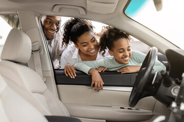 Cheerful Black Family Of Three Buying And Choosing New Car