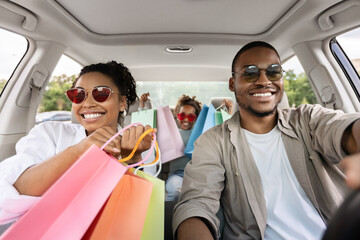 Wall Mural - Happy Black Parents And Daughter Riding Car After Shopping