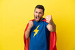 © luismolinero - Young handsome caucasian man isolated on yellow background in superhero costume and fighting