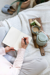 Wall Mural - Female hands hold pen and personal diary with blank pages