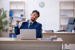 © Elnur - Young male employee working in the office
