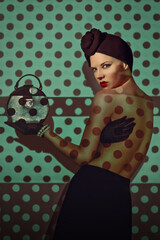 Beautiful young woman from the 20s wearing a turban and holding a small round purse, a polka dot pattern projected onto her body and background