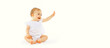 Cute baby looking up sitting on the floor greeting waving his hand on white background, banner blank copy space for advertising text