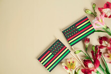 Creative Background For Juneteenth Day With Black Liberation African American Flags And Bright Flowers