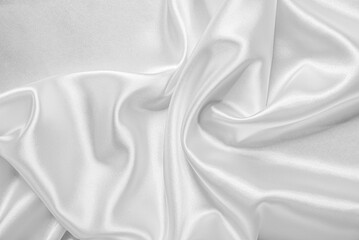 Closeup of rippled white silk fabric. White silk fabric as an abstract background.