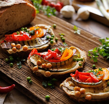 Vegetarian Sandwiches With Hummus And Various Vegetables On A Wooden Board, Close-up View. Healthy Food
