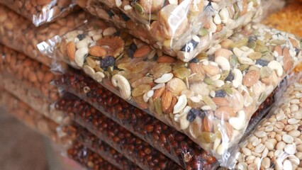 Wall Mural - close up of many mixed nuts in a plastic packet 