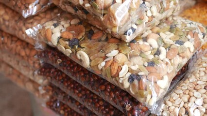 Canvas Print - close up of many mixed nuts in a plastic packet 