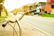 © Sophon_Nawit - Closeup handlebars of vintage bike which parked on pavement beside the rural road in the city, soft and selective focus.