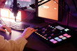 © Seventyfour - Unrecognizable woman preparing to to record podcast adjusting sound settings using mixing console