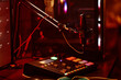 © Seventyfour - Horizontal no people shot of microphone and small mixing console on table at night, home radio or podcast studio concept