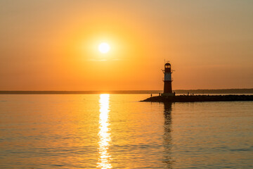 Wall Mural - lighthouse ostmole warnemünde at sunrise, rostock, germany