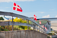 Danish Flags In A Row On A Wooden Fence In A Village