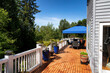 © tab62 - Home wood deck with patio furniture and plants for the summer season