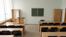 Empty Tables And Chairs In Classroom. Camera Moving Top Down