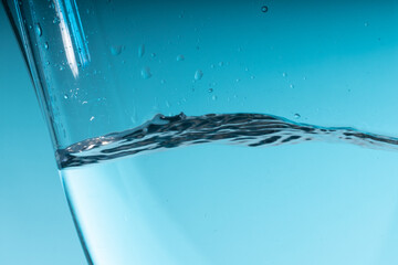 Sticker - beautiful blue splash of water in a glass vessel. clean clear water