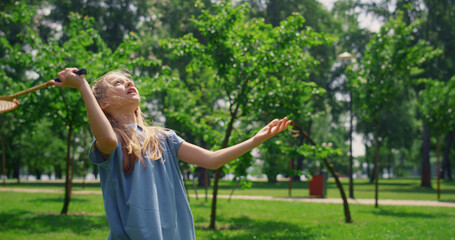 Pretty girl playing badminton on nature close up. Sporty child enjoy game.