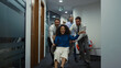 © stockbusters - Business group racing chair having fun party in diverse office workplace hallway