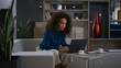 © stockbusters - Busy african american businesswoman typing laptop keyboard drink coffee on work.