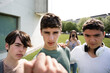 Bullied person view of aggressive friends menacing. Bullying and violence on teenagers concept.