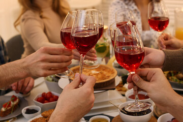 Sticker - Group of people clinking glasses with red wine during brunch at table indoors, closeup