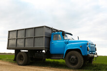 Truck With Seedlings In Field On Spring Day. Agricultural Industry