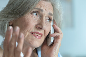 Sticker - sad senior woman talking on phone