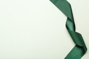 Wall Mural - Beautiful green ribbon on white background, top view. Space for text