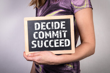 Wall Mural - DECIDE COMMIT SUCCEED. Chalk board in a woman's hands