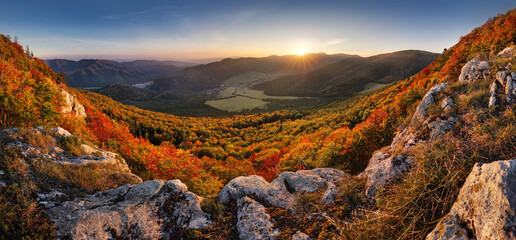 Majestic trees with sunny beams at mountain valley. Dramatic and picturesque morning scene. Red and yellow leaves. Warm toning effect. Carpathians,  Slovakia, Europe. Beauty world.