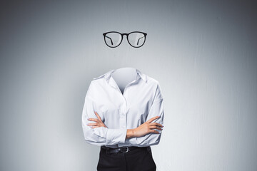 headless invisible businesswoman with folded arms and abstract glasses standing on gray wall backgro