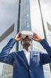 © Westend61 - Businessman wearing virtual reality simulator in front of modern building