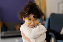 Cute Little Girl Wearing Oversized Eyeglasses Hugging Self
