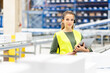 © Westend61 - Young worker wearing headset standing with tablet PC in warehouse