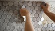 Laying mosaic tiles by the hands of a master. Mosaic tile gluing. The master glues mosaic ceramic tiles on the wall.