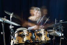 Happy Drummer Playing Drum Kit Against Black Background