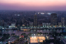 Egypt, Cairo, Elevated View Of Gezira, Agouza,DokkiandMohandeseendistricts At Dusk With Sporting Clubs In Foreground