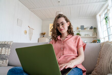Young Businesswoman Wearing Eyeglasses Working On Laptop At Home
