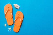 Flat Lay Composition With Flip Flops And Seashell On Colored Background. Space For Text Top View
