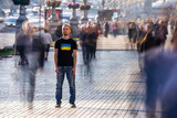 Fototapeta Miasto - The man stands on the crowded street.