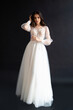 © alipko - Full length portrait of young beautiful woman wearing white wedding dress. Elegant bride standing and posing
