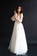 © alipko - Full length portrait of young beautiful woman wearing white wedding dress. Elegant bride standing and posing