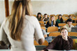 © DisobeyArt - Teacher working with students inside classroom at school university