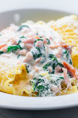 Wall Mural - pasta with creamy salmon sauce with spinach