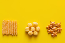 Top View Of Tasty French Fries, Cheese Pops And Bakes Star Shape Cookies On Yellow